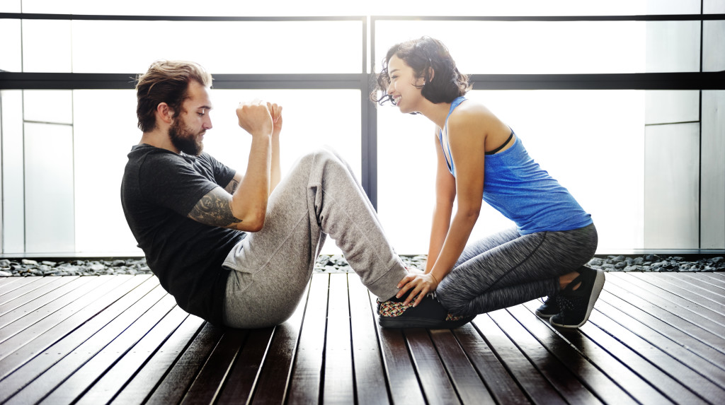 Couple exercising together sit ups