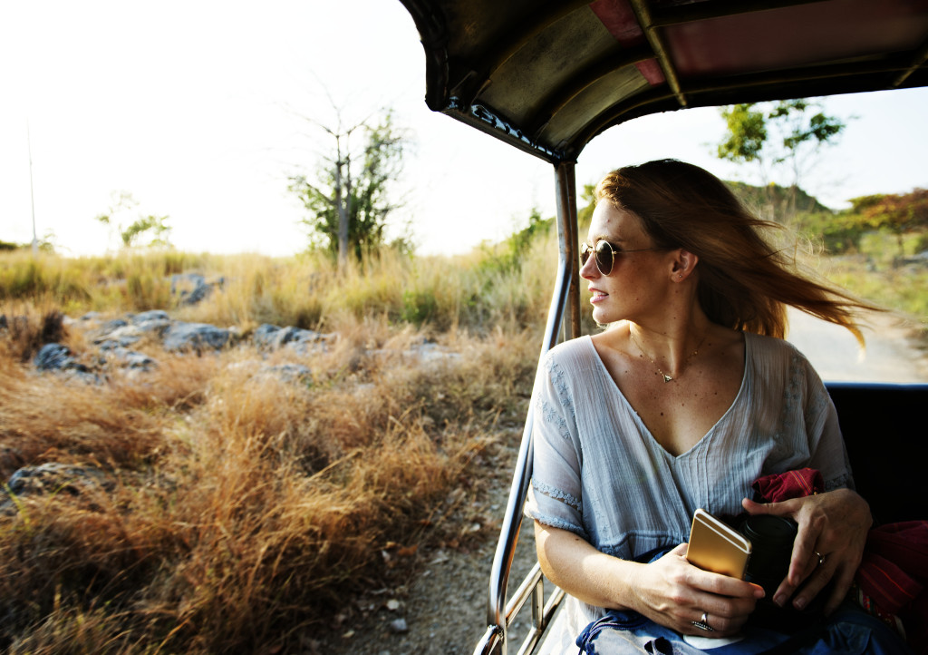 Young woman on the road trip to the nature
