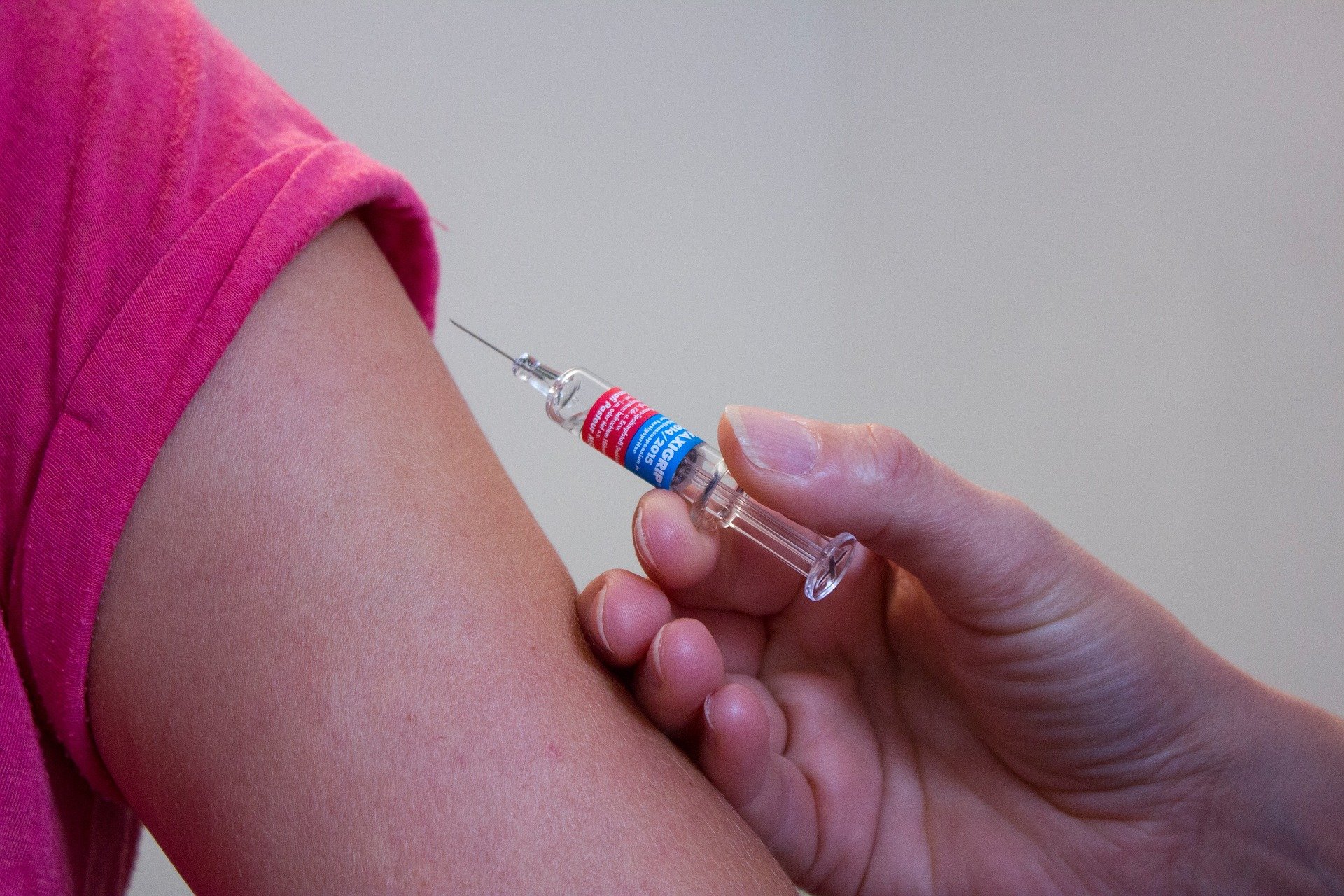 women getting vaccination shot in arm